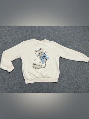 H&M Cream Sweatshirt with Cat Graphic and Blue Bow